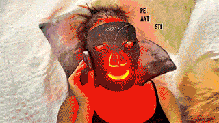 person-wearing-red-light-face-mask.gif