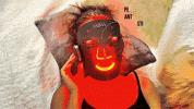person-wearing-red-light-face-mask.gif